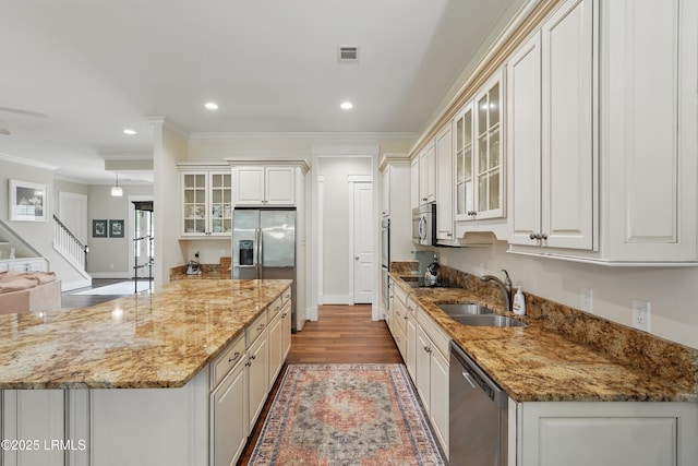 27 Normandy Ave, Bluffton, SC 29910 - kitchen featuring a sink, appliances with stainless steel finishes, crown molding, wood finished floors, and glass insert cabinets