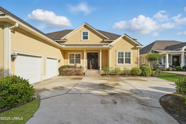 27 Normandy Ave, Bluffton, SC 29910 - view of front of property featuring stucco siding, driveway, and a garage