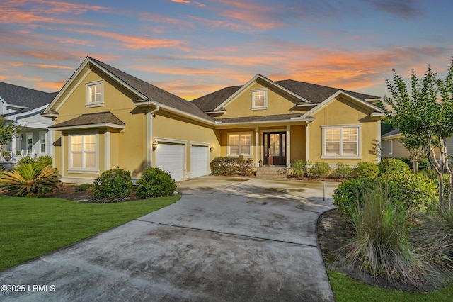 27 Normandy Ave, Bluffton, SC 29910 - traditional-style home with stucco siding, concrete driveway, a front yard, and a garage