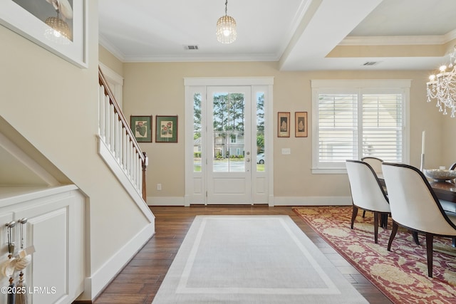 27 Normandy Ave, Bluffton, SC 29910 - entrance foyer featuring a chandelier, dark wood finished floors, baseboards, ornamental molding, and stairway
