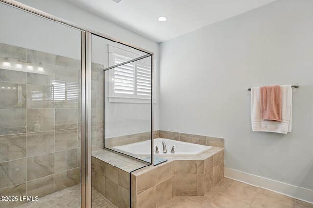 27 Normandy Ave, Bluffton, SC 29910 - full bathroom featuring a shower stall, a bath, and baseboards