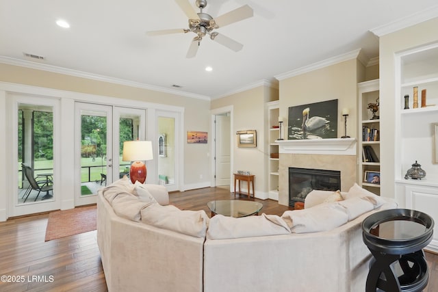 27 Normandy Ave, Bluffton, SC 29910 - living room featuring wood finished floors, a high end fireplace, ornamental molding, a ceiling fan, and baseboards