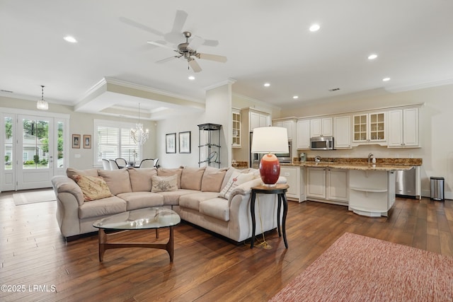 27 Normandy Ave, Bluffton, SC 29910 - living area with ornamental molding, dark wood finished floors, recessed lighting, a chandelier, and a ceiling fan