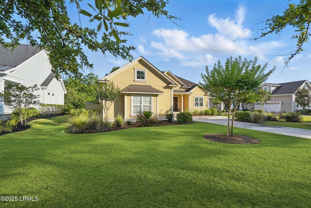 27 Normandy Ave, Bluffton, SC 29910 - view of front facade with stucco siding, a front lawn, and driveway