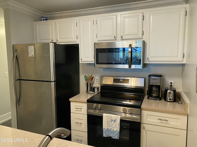 171 Beach Club Villa Dr Unit 171, Fripp Island, SC 29920 - kitchen with appliances with stainless steel finishes, white cabinets, ornamental molding, and light stone countertops