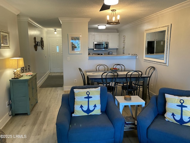 171 Beach Club Villa Dr Unit 171, Fripp Island, SC 29920 - dining area featuring light wood-style floors, ornamental molding, and a chandelier