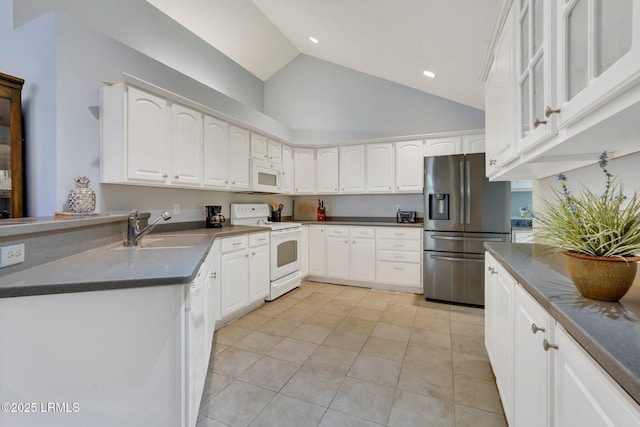 1980 Abbey Glen Way Unit 1980, Hardeeville, SC 29927 - kitchen with white appliances, light tile patterned flooring, a sink, white cabinetry, and dark countertops