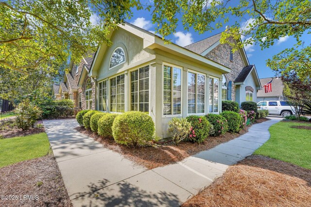 1980 Abbey Glen Way Unit 1980, Hardeeville, SC 29927 - view of property exterior with stucco siding and stone siding