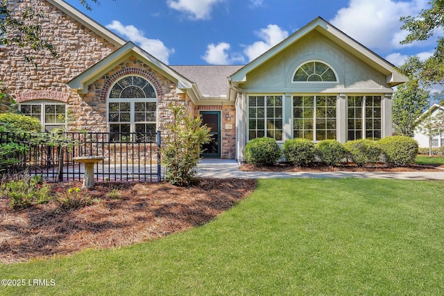 1980 Abbey Glen Way Unit 1980, Hardeeville, SC 29927 - ranch-style house featuring stone siding, stucco siding, a front lawn, and fence