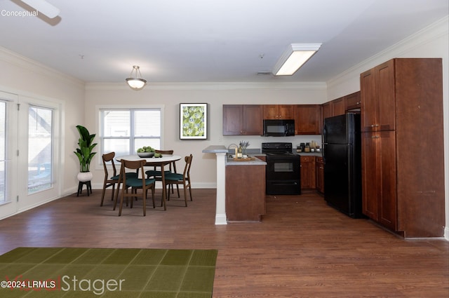 kitchen featuring ornamental molding, dark hardwood / wood-style floors, a kitchen island, and black appliances