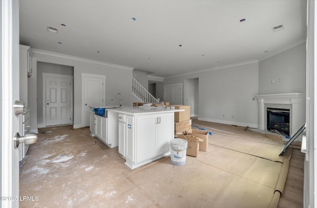 1 Alumni Rd, Beaufort, SC 29907 - kitchen featuring visible vents, a fireplace with flush hearth, open floor plan, an island with sink, and a sink