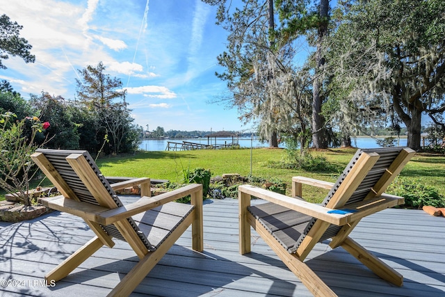 wooden deck with a lawn and a water view