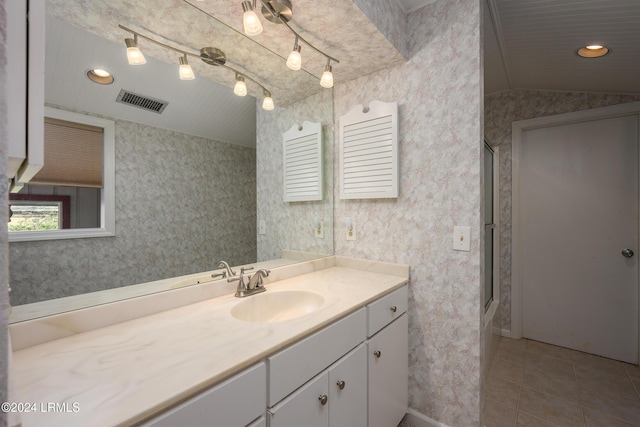 bathroom with tile patterned flooring, an enclosed shower, vanity, and lofted ceiling