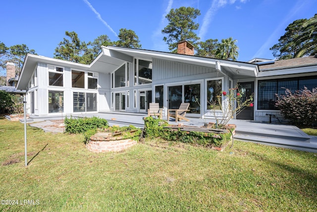 back of house featuring a yard