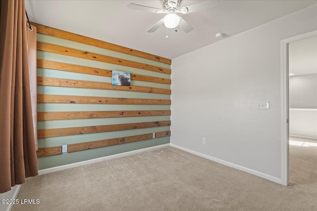 unfurnished room with light colored carpet and ceiling fan