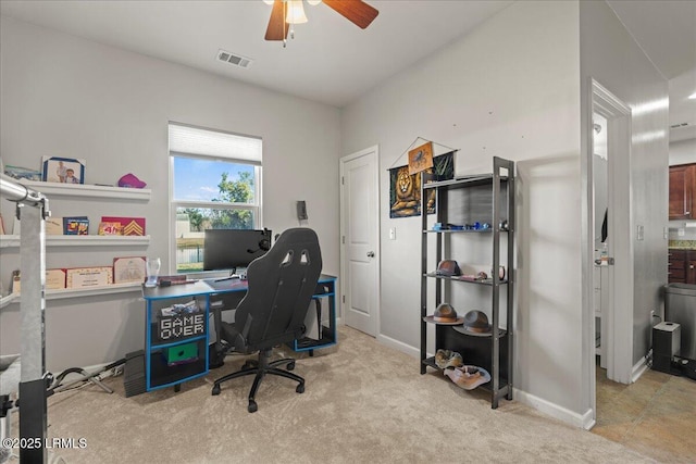 office space with light carpet and ceiling fan