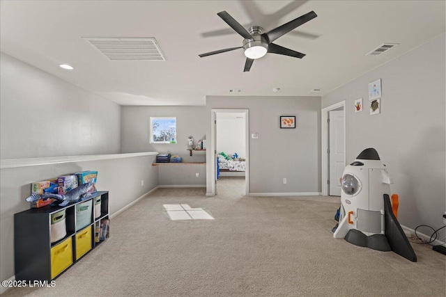 rec room featuring light carpet and ceiling fan