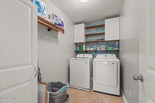 laundry room featuring cabinets and washing machine and clothes dryer