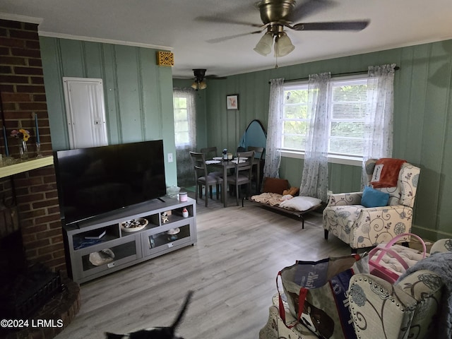 living room with plenty of natural light, ceiling fan, and light hardwood / wood-style flooring