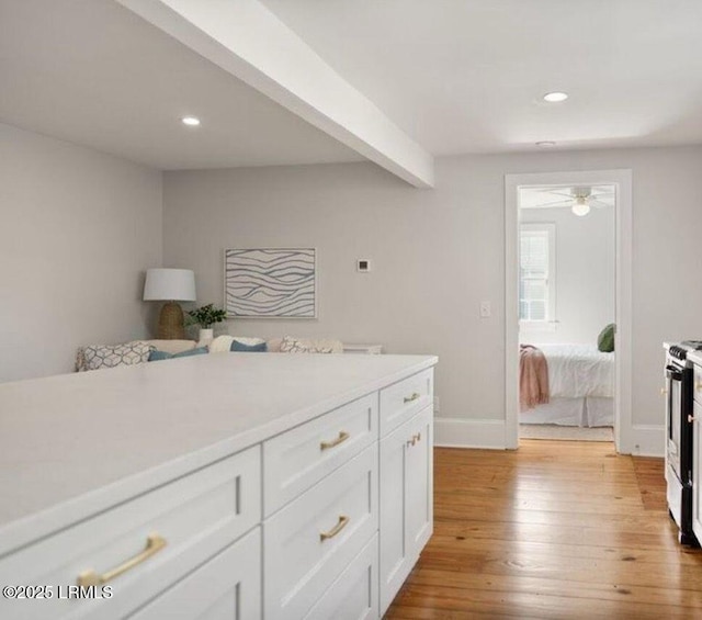 606 Carteret St Unit 2, Beaufort, SC 29902 - kitchen with stainless steel gas range, light countertops, light wood-style floors, recessed lighting, and white cabinetry