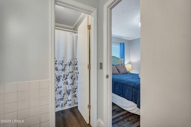 bathroom with ornamental molding, baseboards, wood finished floors, and ensuite bathroom