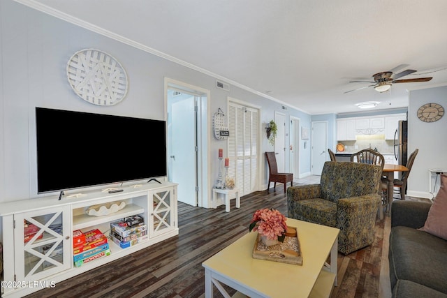 living room with crown molding, a ceiling fan, and dark wood finished floors
