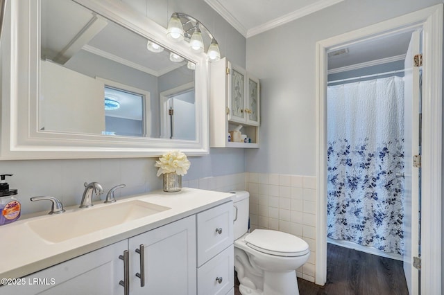bathroom featuring tile walls, vanity, curtained shower, toilet, and wood finished floors