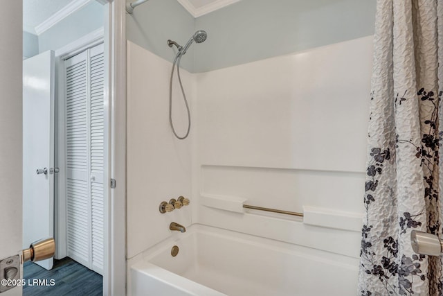 bathroom featuring wood finished floors, shower / bath combination with curtain, and ornamental molding