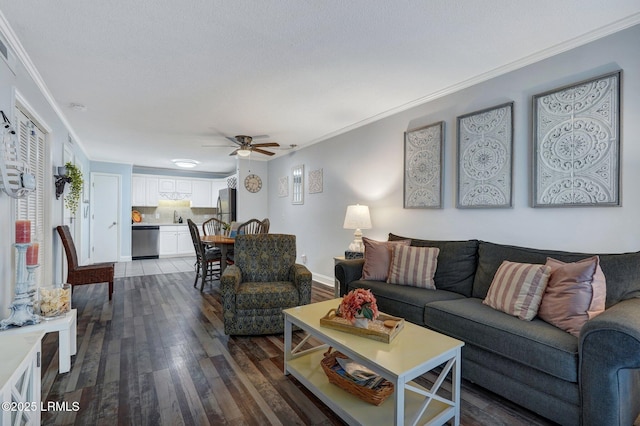 living area featuring ornamental molding, a ceiling fan, and dark wood-style flooring
