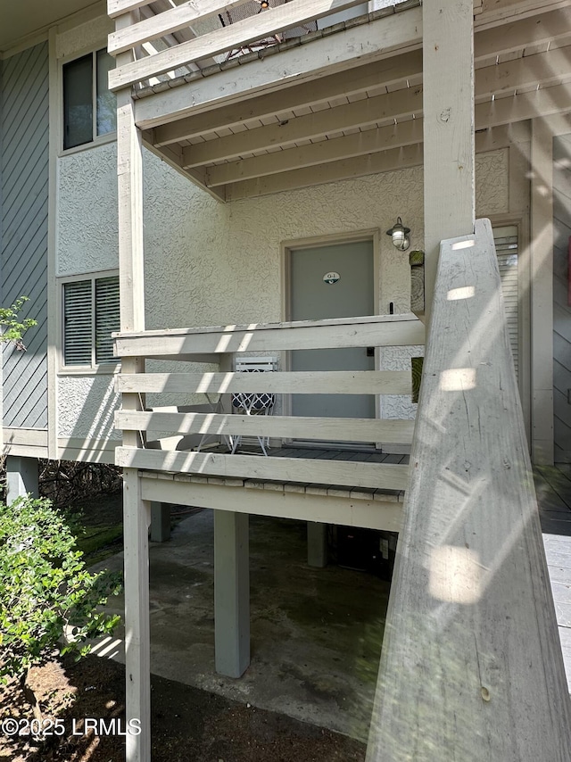 doorway to property featuring stucco siding