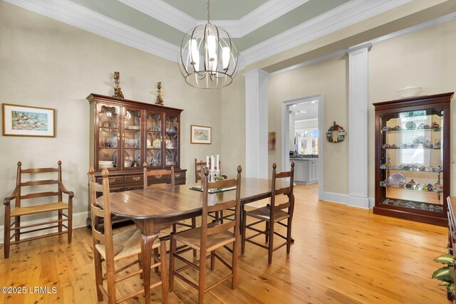 44 Richland Dr, Bluffton, SC 29910 - dining room featuring ornamental molding, light wood-style flooring, decorative columns, and a chandelier