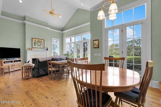 44 Richland Dr, Bluffton, SC 29910 - dining area featuring crown molding, high vaulted ceiling, ceiling fan, a fireplace, and light wood-style flooring