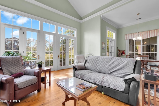 44 Richland Dr, Bluffton, SC 29910 - living area featuring a notable chandelier, ornamental molding, light wood-style flooring, visible vents, and lofted ceiling