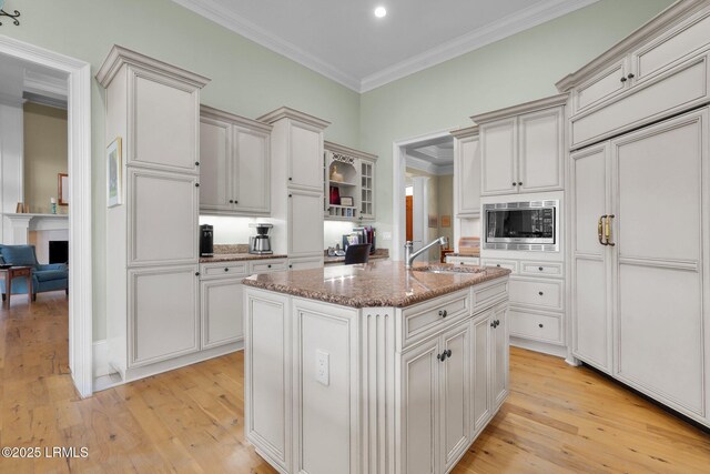 44 Richland Dr, Bluffton, SC 29910 - kitchen with light wood-type flooring, stainless steel microwave, a sink, and ornamental molding