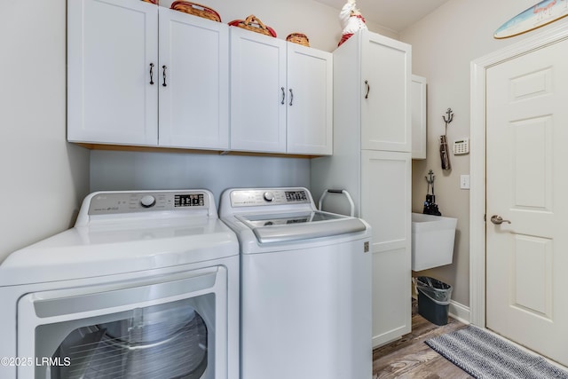 300 Persimmon Cir, Hardeeville, SC 29927 - laundry area featuring separate washer and dryer, cabinet space, and wood finished floors