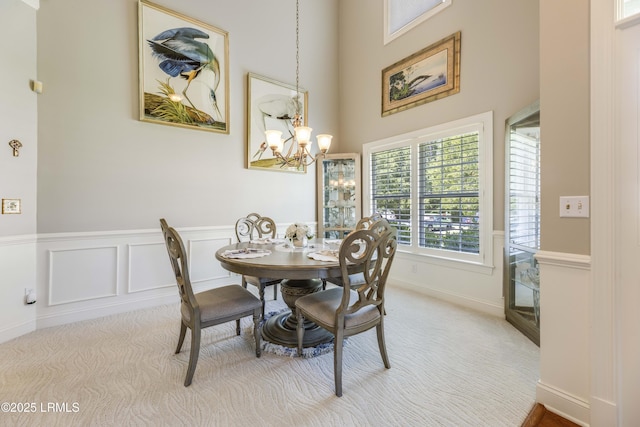 300 Persimmon Cir, Hardeeville, SC 29927 - carpeted dining room with a chandelier, a wainscoted wall, and a high ceiling