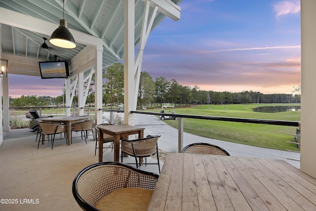 300 Persimmon Cir, Hardeeville, SC 29927 - patio terrace at dusk with outdoor dining area, view of golf course, and a patio area