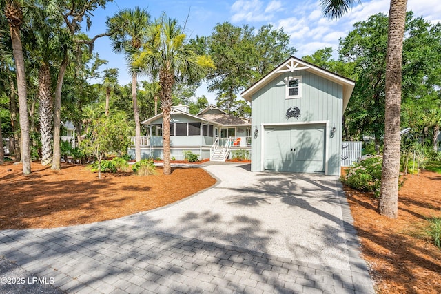 106 Sand Piper Run, Fripp Island, SC 29920 - view of front of house with decorative driveway, board and batten siding, and a sunroom