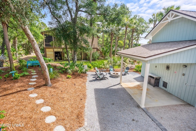 106 Sand Piper Run, Fripp Island, SC 29920 - view of yard featuring an outdoor fire pit, a patio area, and a sunroom