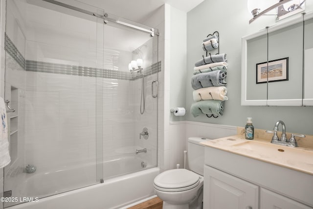 106 Sand Piper Run, Fripp Island, SC 29920 - bathroom featuring combined bath / shower with glass door, vanity, and a wainscoted wall