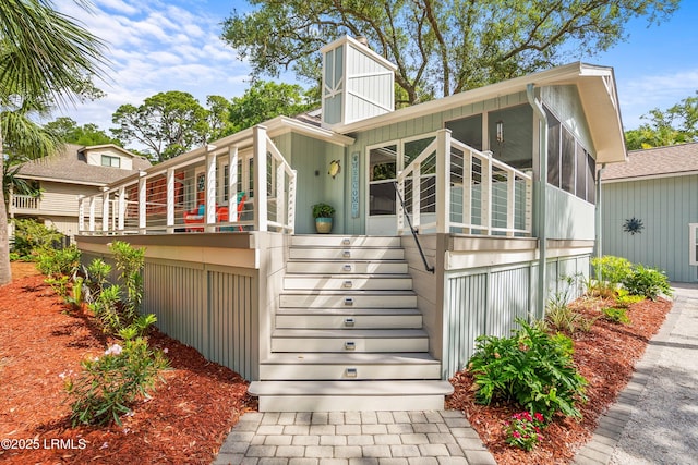 106 Sand Piper Run, Fripp Island, SC 29920 - view of front of house featuring a sunroom, stairs, and a chimney