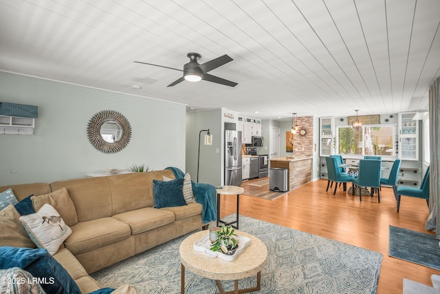 106 Sand Piper Run, Fripp Island, SC 29920 - living room featuring light wood-style floors, ceiling fan, wooden ceiling, and a chandelier