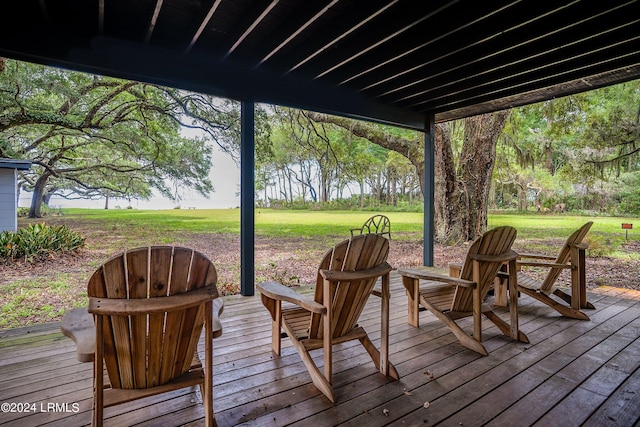 wooden deck featuring a lawn