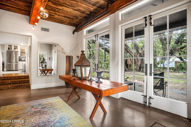 interior space featuring beamed ceiling, a wealth of natural light, and wooden ceiling