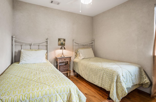 bedroom featuring wood-type flooring and ceiling fan