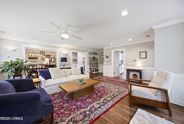 51 White Oaks Cir, Bluffton, SC 29910 - living area featuring built in shelves, crown molding, a chandelier, ceiling fan, and wainscoting