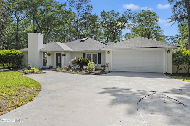 51 White Oaks Cir, Bluffton, SC 29910 - single story home with concrete driveway, stucco siding, a garage, a chimney, and roof with shingles