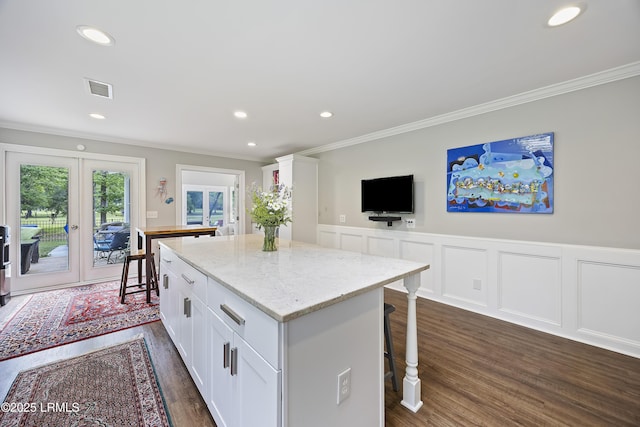 51 White Oaks Cir, Bluffton, SC 29910 - kitchen with ornamental molding, dark wood-style flooring, french doors, a center island, and white cabinetry