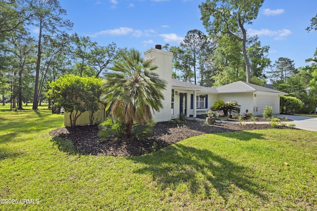 51 White Oaks Cir, Bluffton, SC 29910 - view of front of home featuring driveway, a garage, a chimney, a front yard, and stucco siding