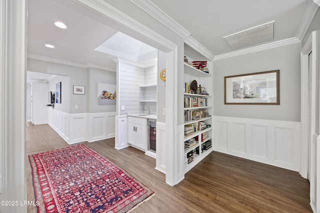 51 White Oaks Cir, Bluffton, SC 29910 - hallway with dark wood-style floors, wine cooler, crown molding, a wainscoted wall, and a decorative wall